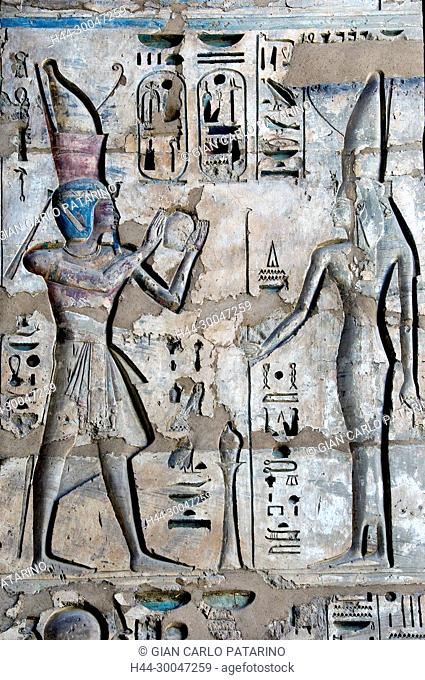 Medinet Habu, Luxor, Egypt, Djamet, mortuary temple of King Ramses III, XX dyn. 1185 -1078 B.C: the king offers a vase to goddess Mut
