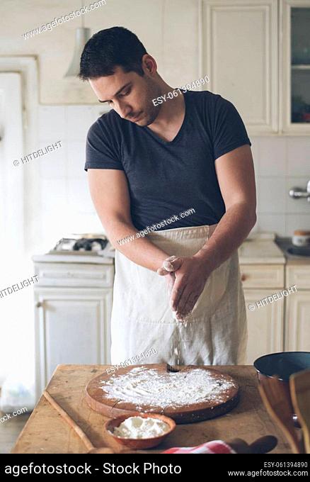 Man baking bread in kitchen