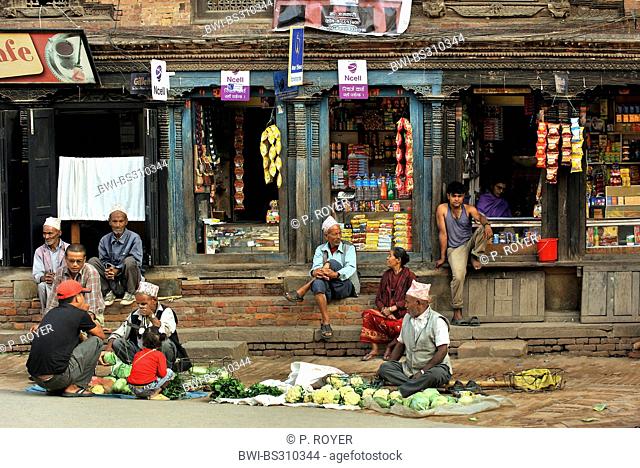 people sitting in front of shops in a street of the small town near Katmandoo, Nepal, Patan