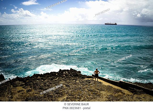A man looking at a cargo, Gosier island, Guadeloupe, France