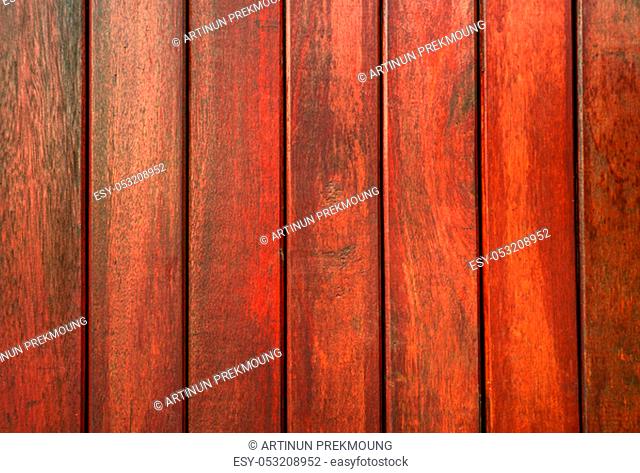 Closeup red wood with unique pattern texture background with copy space for text. Wooden background for construction site
