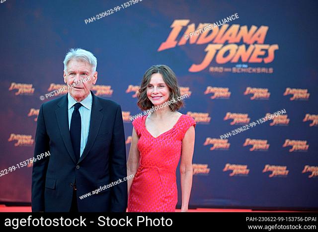 22 June 2023, Berlin: Harrison Ford and Calista Flockhart stand on the red carpet at the German premiere of the film ""Indiana Jones and the Wheel of Destiny""...