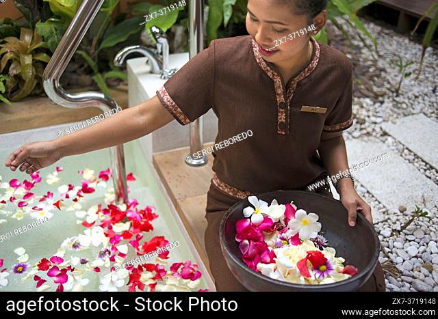 Preparing the bath with flowers and bath salls in the Spa of Anantara Si Kao Resort & Spa, south of Krabi, Thailand. Located on the soft white sands of...