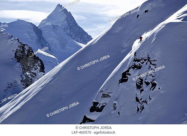 Freeskier downhill skiing in deep snow, Chandolin, Canton of Valais, Switzerland