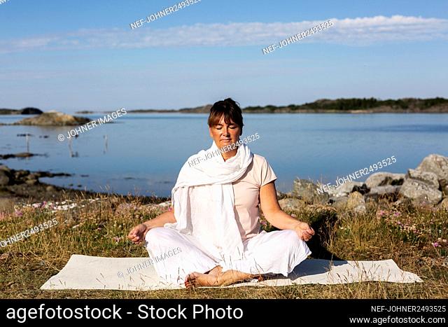 Woman meditating at sea