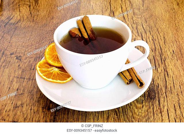 Cup of orange tea with cinnamon