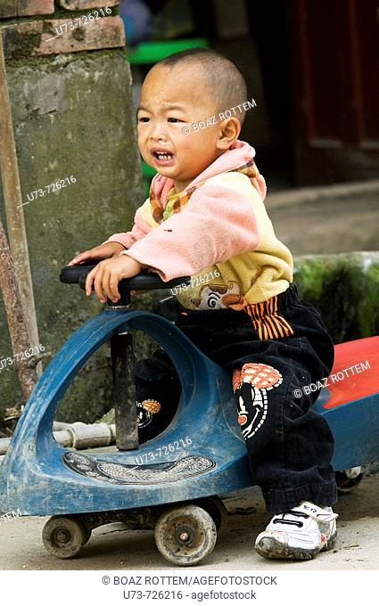 Chinese baby playing near his house