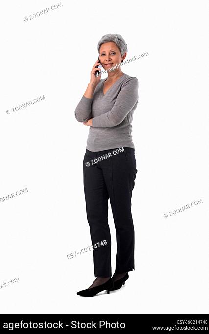 Beautiful mature Asian woman business talking on mobile phone