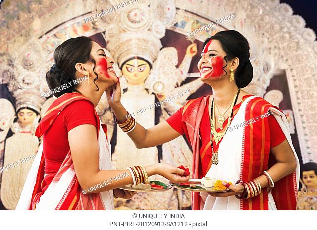 Bengali women celebrating Durga Puja