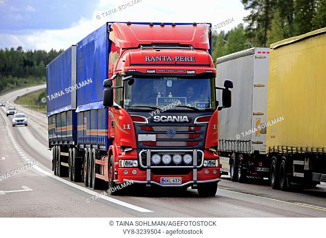 Orivesi, Finland - August 27, 2018: Two freight trucks, red Scania Ranta-Pere and another transporter meet at speed on highway 4 in Central Finland