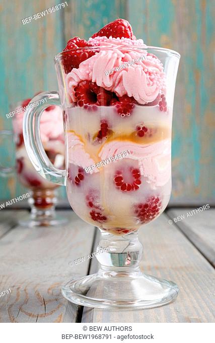 Raspberry layer dessert on wooden background, party dessert