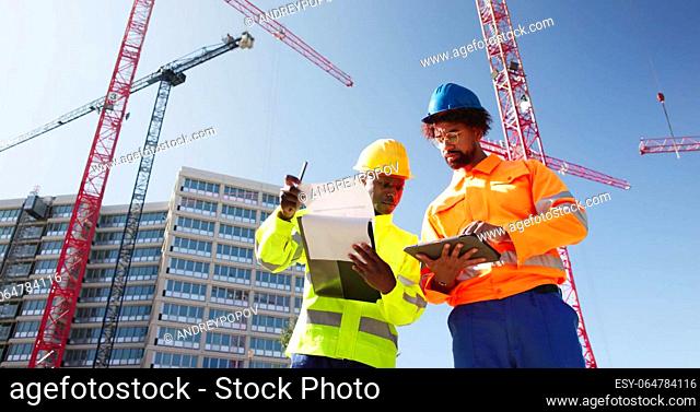 OSHA Inspector At Construction Site. Young Engineer Worker