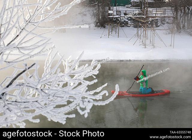 RUSSIA, NOVOSIBIRSK - DECEMBER 8, 2023: A stand up paddle boarder is seen on the Ob River as severe frost hits the city. On 8 December