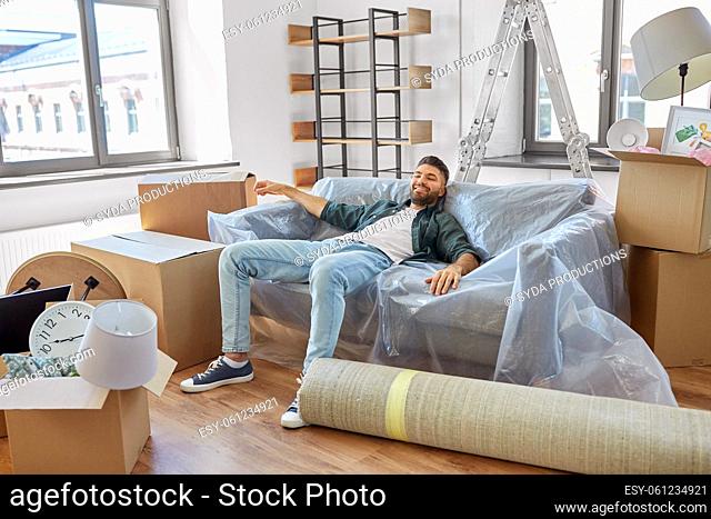 happy man with boxes moving to new home