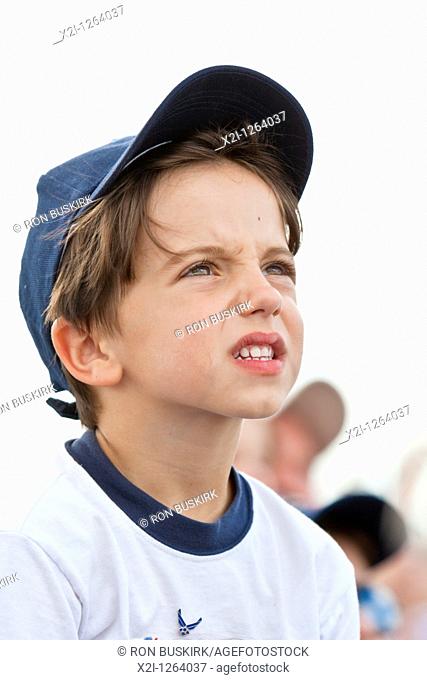 Young child with US Air Force pin watches the skys during air show at NAS Jacksonville, Florida