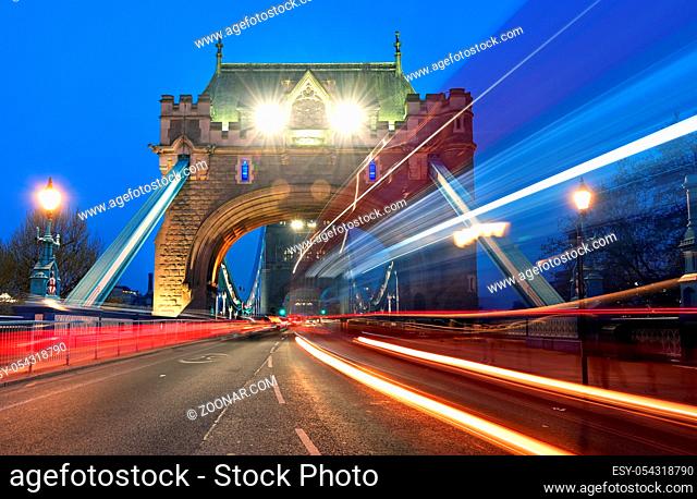 Vehicles pass over Tower Bridge across the River Thames in London, UK