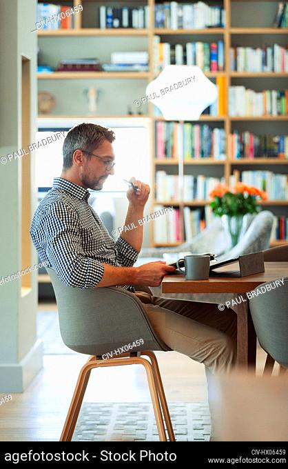 Businessman using digital tablet, working from home