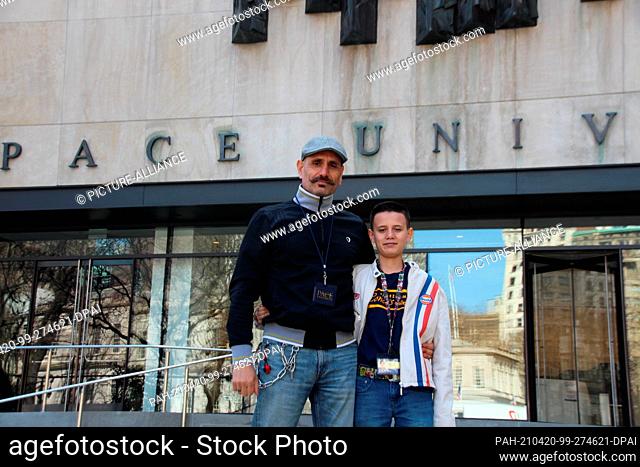 23 March 2021, US, New York: Bardia Gharib (l) stands proudly with his son Shahab Gharib in front of the entrance to Pace University