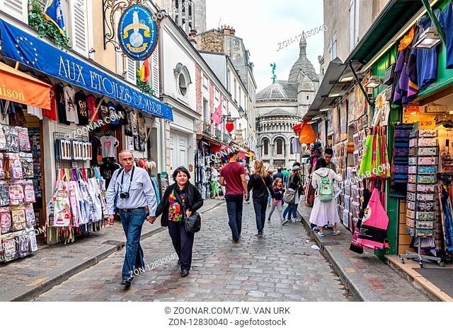 PARIS, FRANCE - May 28: Tourists walking near the gift shops of Montmartre, close to the famous Sacre Coeur Basilica on May 28, 2015, Paris, France