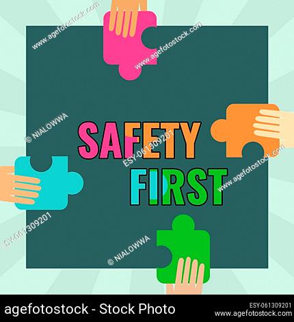 Sign displaying Safety First, Concept meaning used to say that the most important thing is to be safe Illustration Of Hands Holding Puzzle Pieces Each Sides Of...