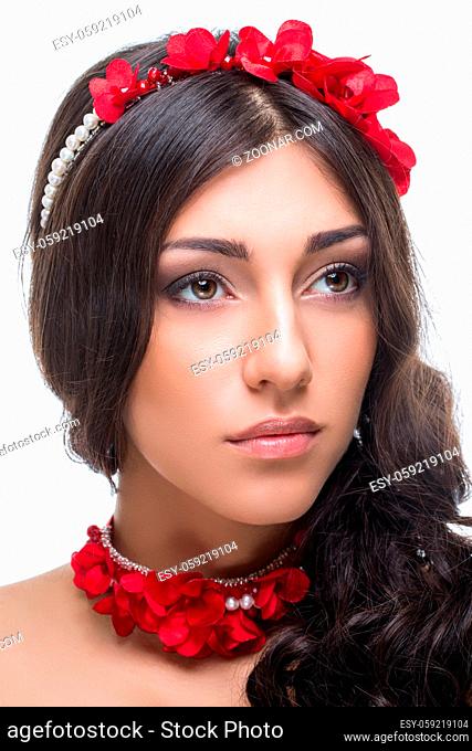 Beautiful brunette young woman with red ribbon headband and bracelets. Beauty shot on white background. Isolated. Copy space