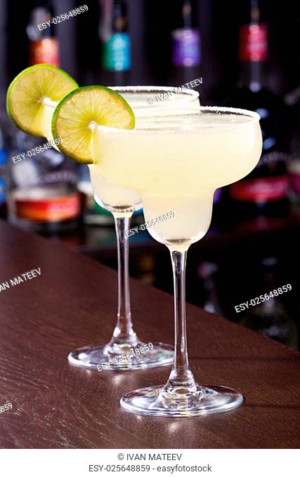 The margarita is a cocktail consisting of tequila mixed with orange-flavoured liqueur and lime or lemon juice, often served with salt on the glass rim