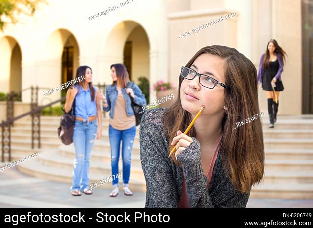 mixed-race young female student walking on campus