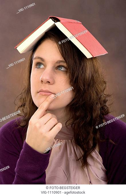 young woman with book on head - 23/12/2008