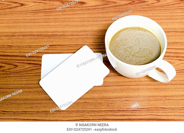 coffee cup and business card on wood background