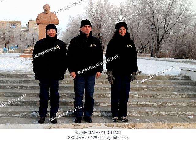 The Expedition 30 backup crew members pose for pictures Dec. 11, 2011 in front of a statue of Sergei Korolev, the Russian Great Designer and driving force...
