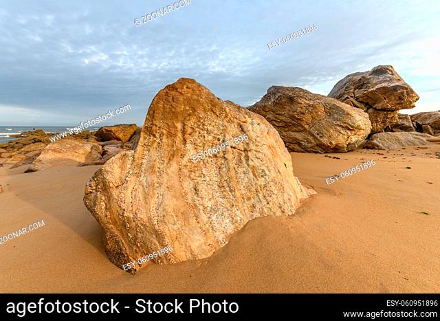Sand beach among rocks in a summer morning in France