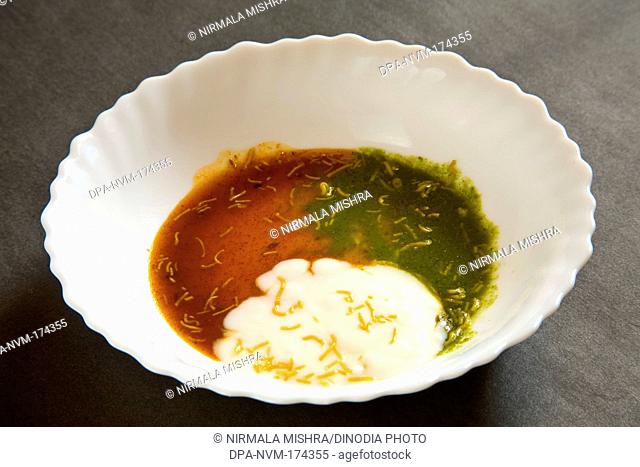 Indian yogurt green coriander and tamarind chutney in bowl on black background 23-April-2010