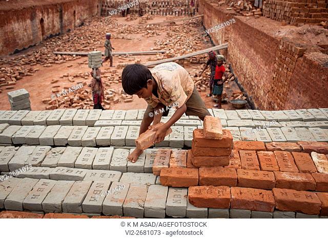 Babu (08) works at a brick factory in Narayangonj, Bangladesh, Jun 01, 2016. He come this place with his family member. This group of people comes from...