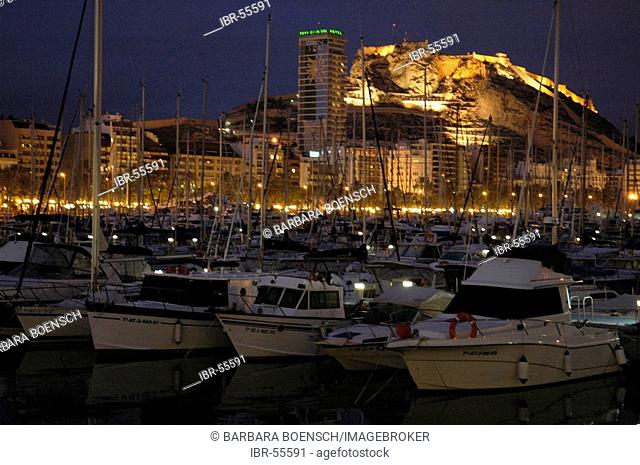 Boats in the port with view of the castellet Santa Barbara because of the evening, Alicante, Costa Blanca, Spain