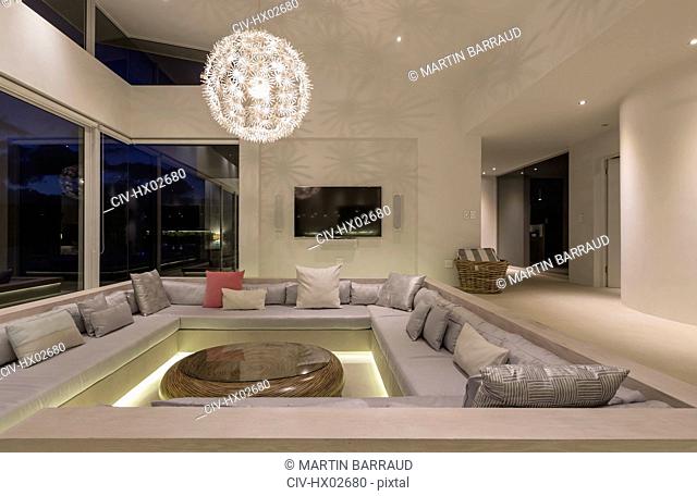 Illuminated modern luxury home showcase interior living room with chandelier