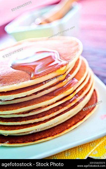 sweet pancakes with honey on the plate