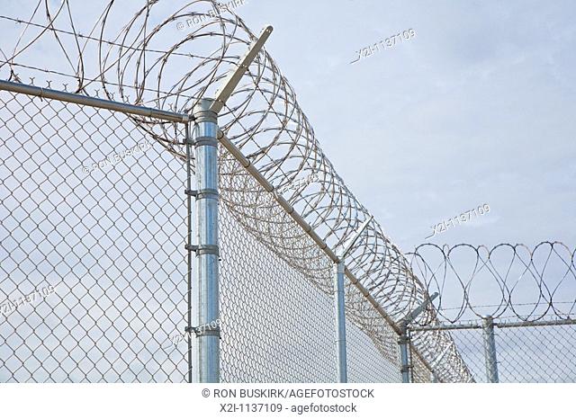 Florida - Feb 2009 - Stainless steel razor wire sprials over chain link fence at correctional facility in central Florida