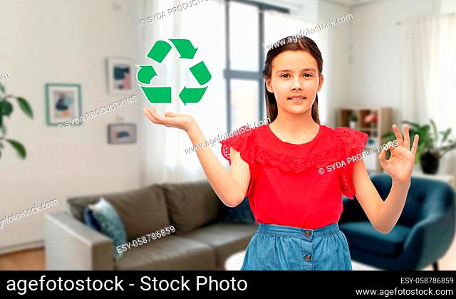 smiling girl with green recycling sign showing ok