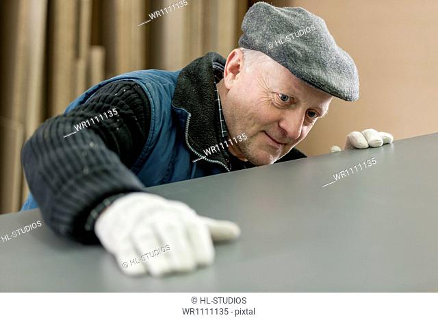 Man checking the surface of a board