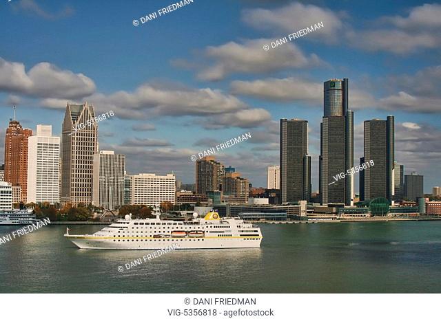 A cruise ship travels along the Detroit River with the skyline of downtown Detroit, Michigan, USA in the background. Detroit is known as The Motor City, The D