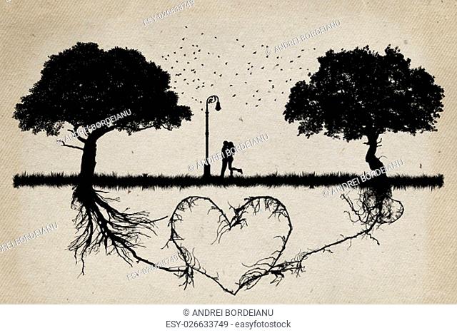 Two trees in front of each other with underground roots growing together in shape of a heart and a couple hugging in the middle
