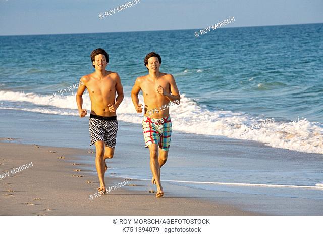 Twins running on the beach, mixed race, Caucasian father and Chinese-American mother
