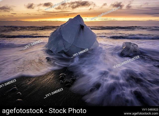 Broken ice from washed up Icebergs on Jokulsarlon black beach at sunset Jokulsarlon South east Iceland