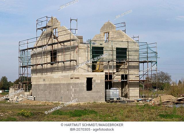 Shell construction surrounded by scaffolding, preparation for roof timbering, private residential building, PublicGround