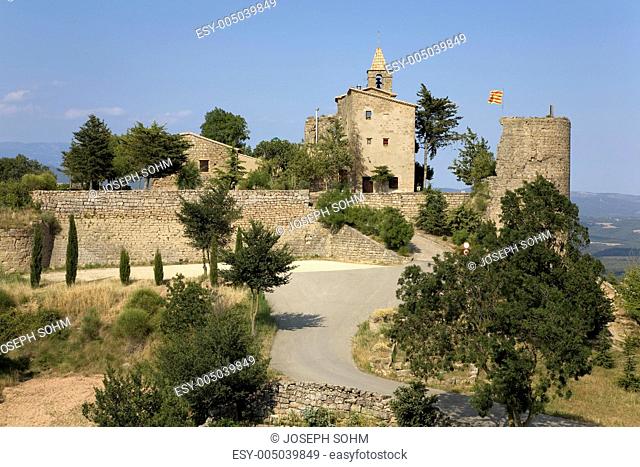 Historic castle flying Spanish flag near village of Solsona, Cataluna, Spain