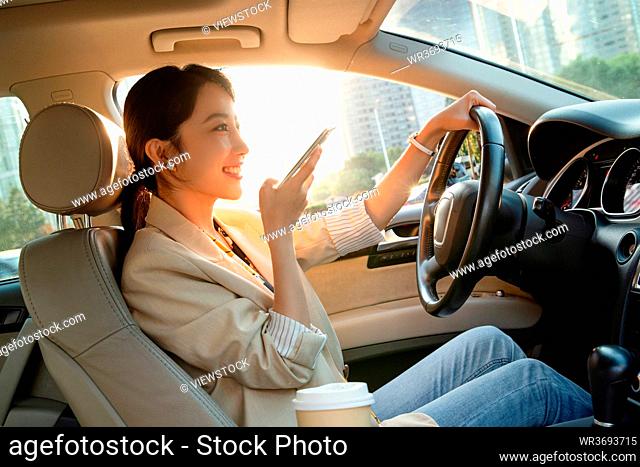 A beautiful young woman while driving voice chat