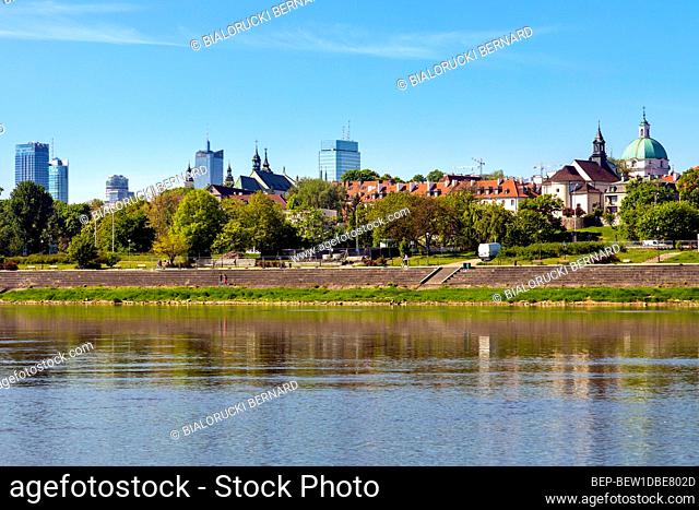 Warsaw, Mazovia / Poland - 2020/05/09: Panoramic view of Warsaw city center and Old Town quarter with Wybrzerze Gdanskie embankment at Vistula river