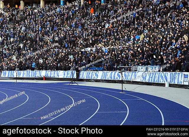 16 December 2023, Berlin: Soccer: Bundesliga 2, Hertha BSC - VfL Osnabrück, matchday 17, Olympiastadion. Hertha fans in the east curve display a banner reading...
