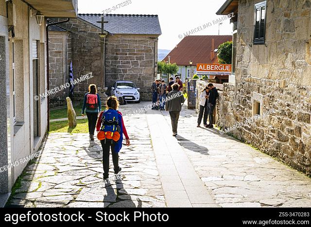 Pilgrims arriving at Palas del Rey next to the Pilgrim's Hostel 'San Marcos'. French Way, Way of St. James. Palas de Rei, Lugo, Galicia, Spain, Europe