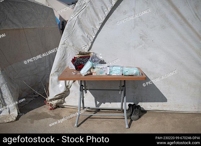 PRODUCTION - 18 February 2023, Turkey, Kahramanmaras: Surgical masks lie on a table in front of a tent in a makeshift camp for people who lost their homes at...